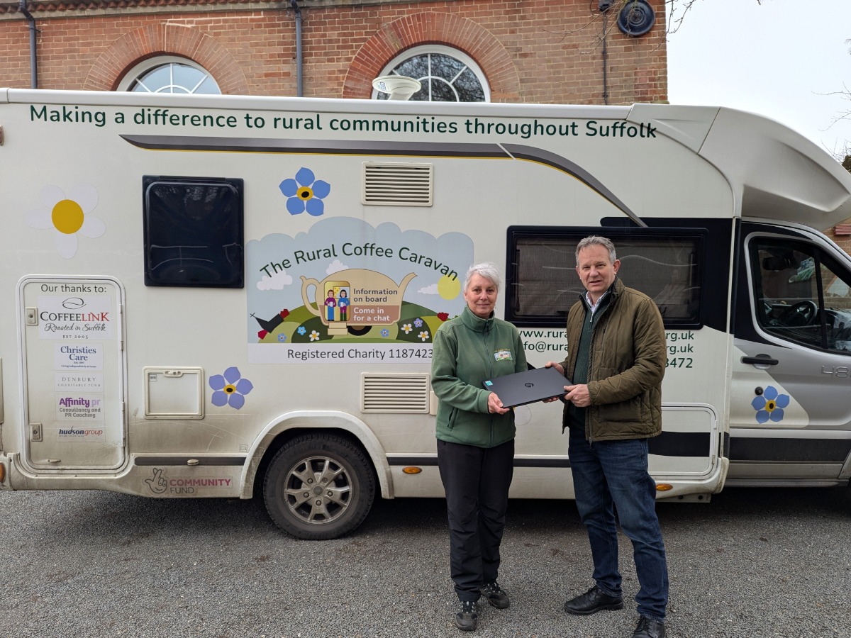 Cllr Andy Mellen and Diana from the Rural Coffee Caravan hold an FCC refurbished device