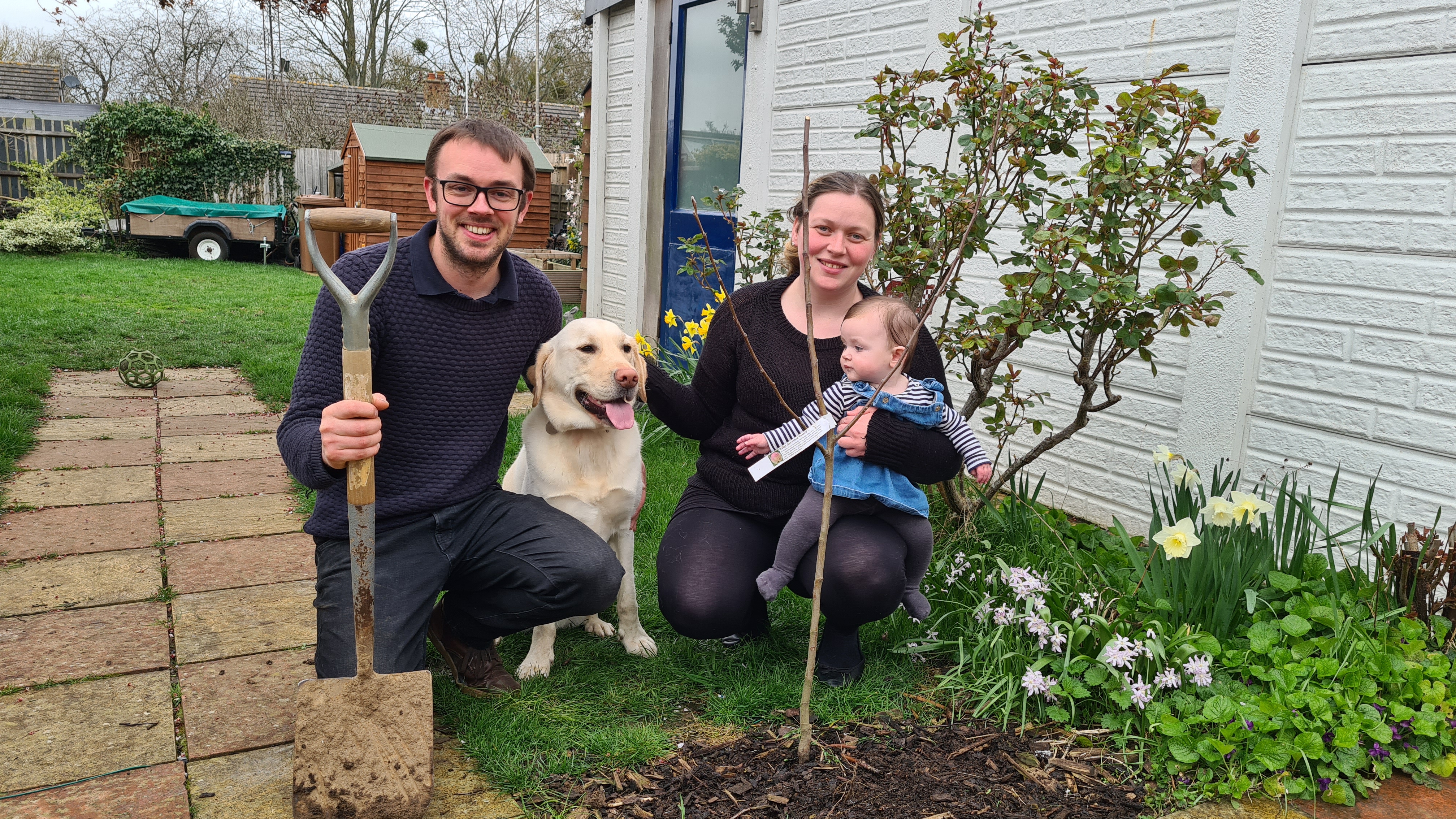 2022 applicant Amelia plants her Tree for Life at home with family